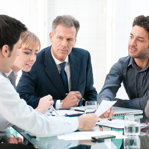 Business people working and discussing together at meeting in office
